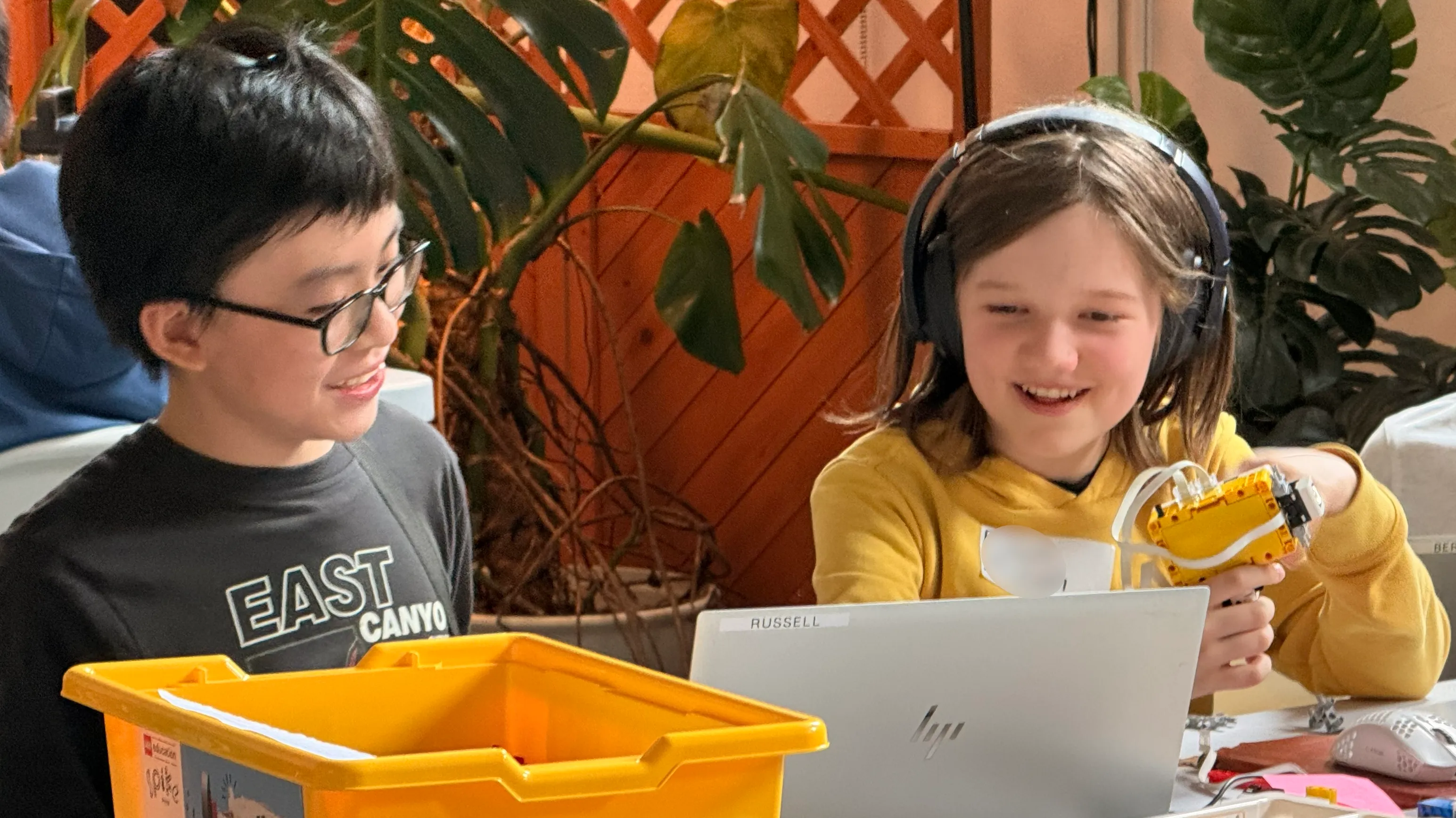 Two members of Purpleroni Pizza prototyping their device